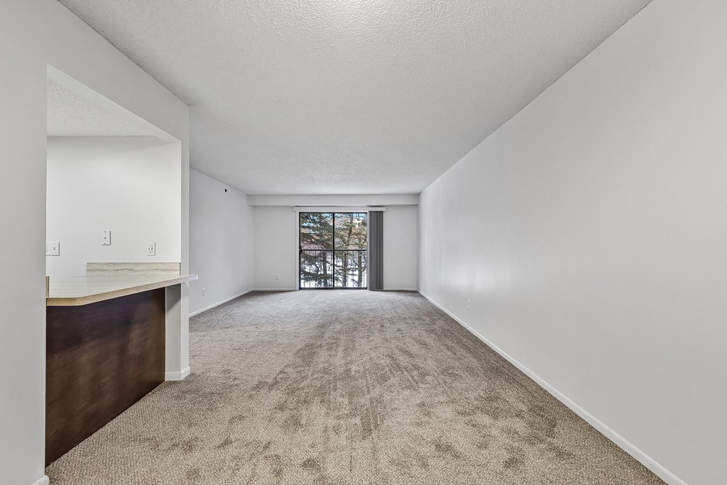 a spacious living room with a kitchenette at the preserve at great pond apartments in windsor