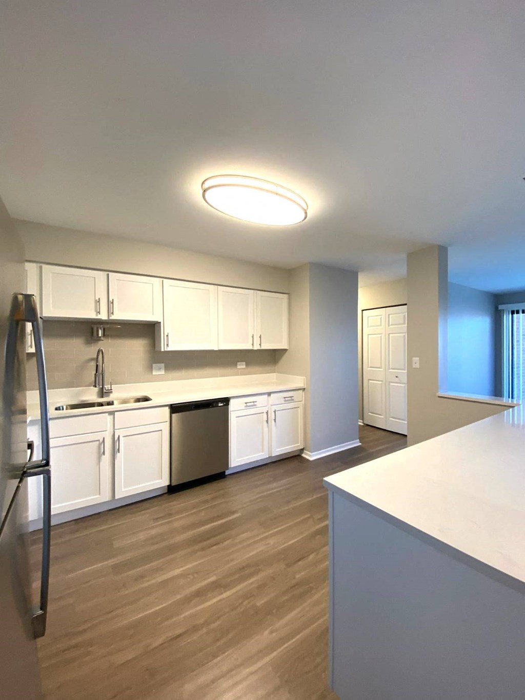 White cabinets with glass backsplash, update lighting and faucets