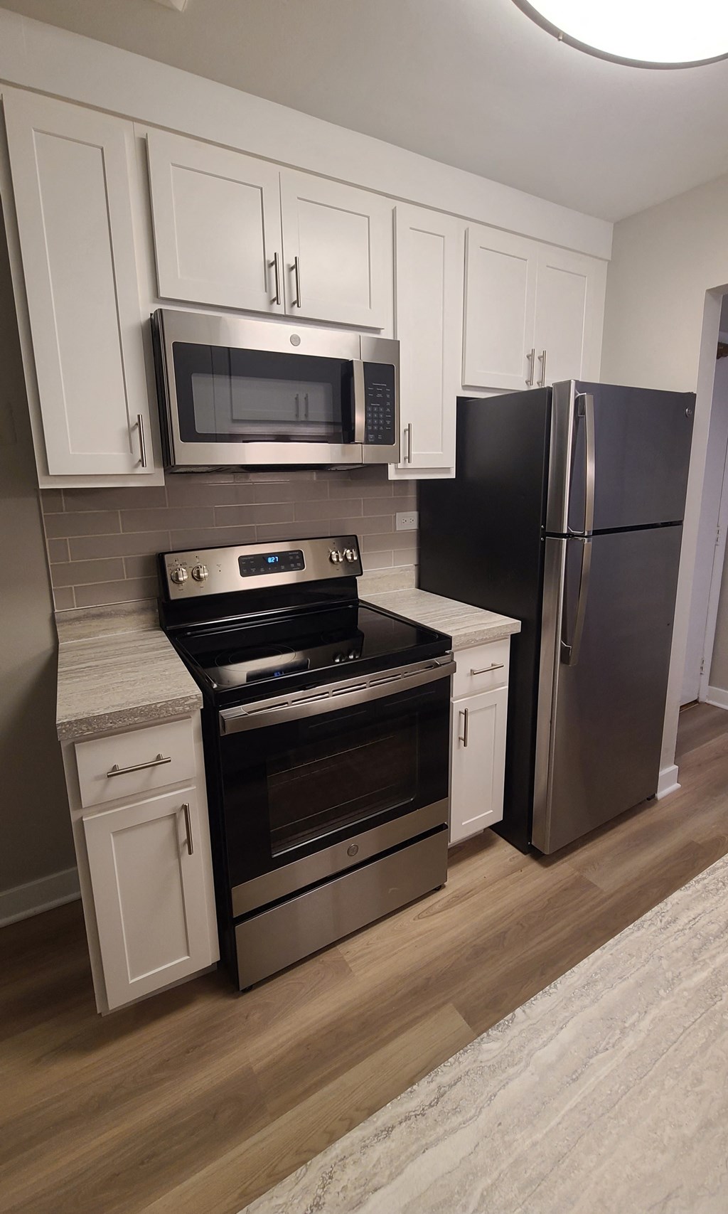 a kitchen with stainless steel appliances and white cabinets