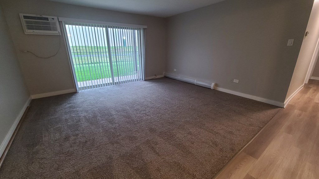 an empty living room with a sliding glass door