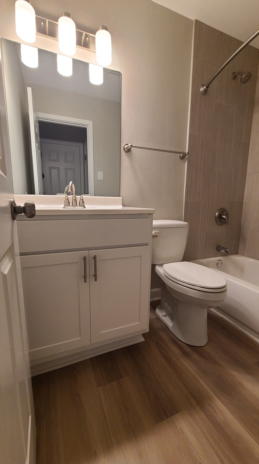 a bathroom with a toilet and a sink and a mirror