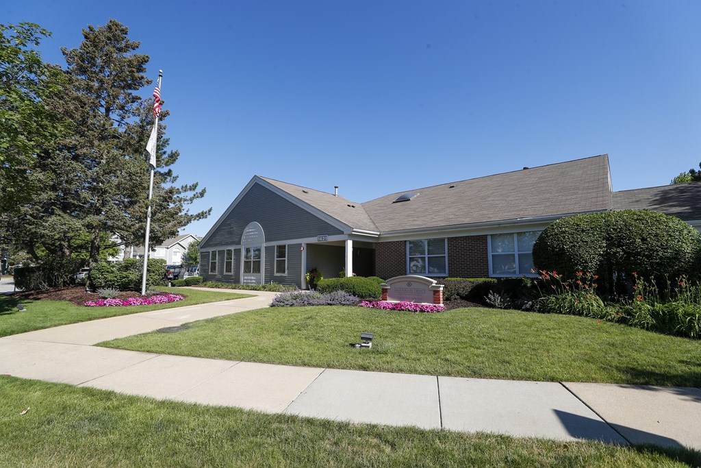 a house with a sidewalk and lawn in front of it
