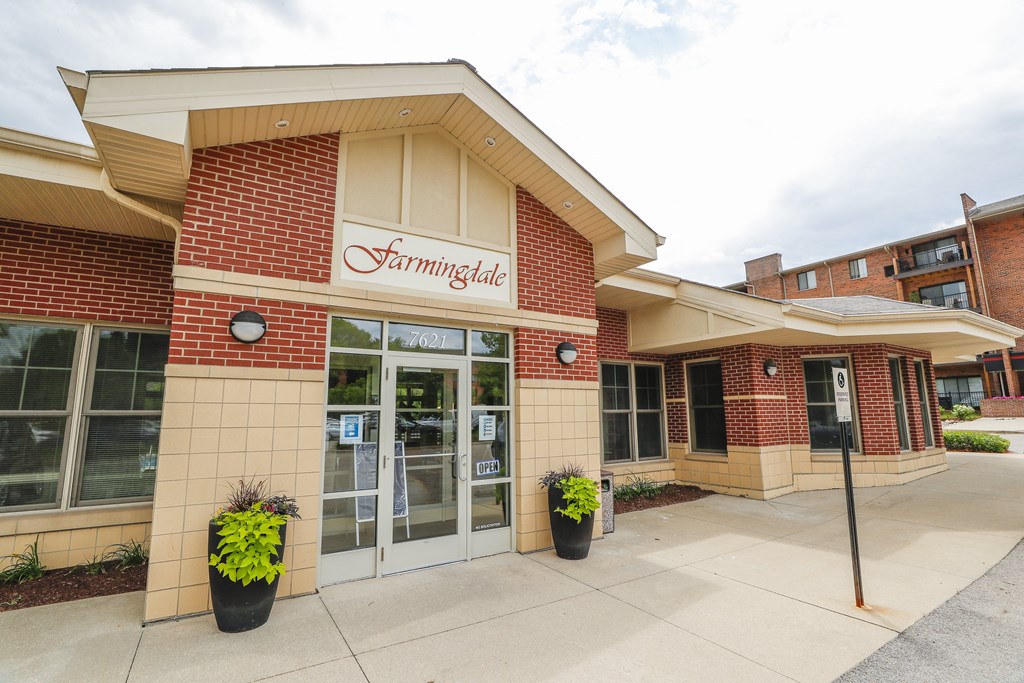 the front of the building with a sidewalk