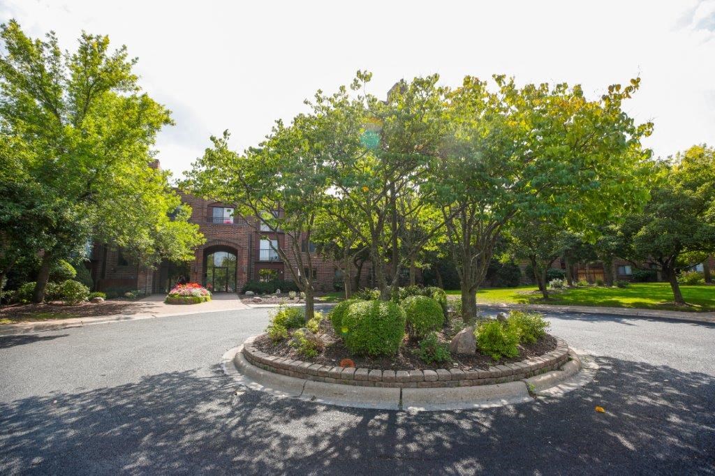 a red brick building with a roundabout in front of it
