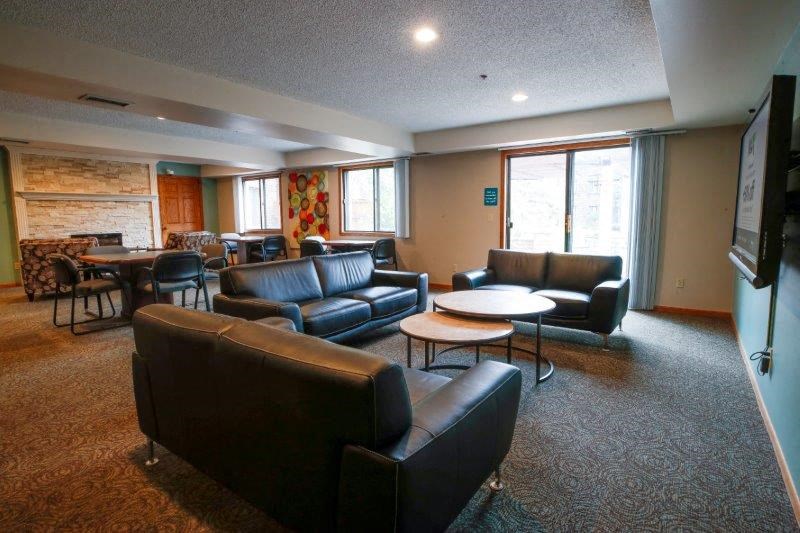 a living room filled with furniture and a flat screen tv