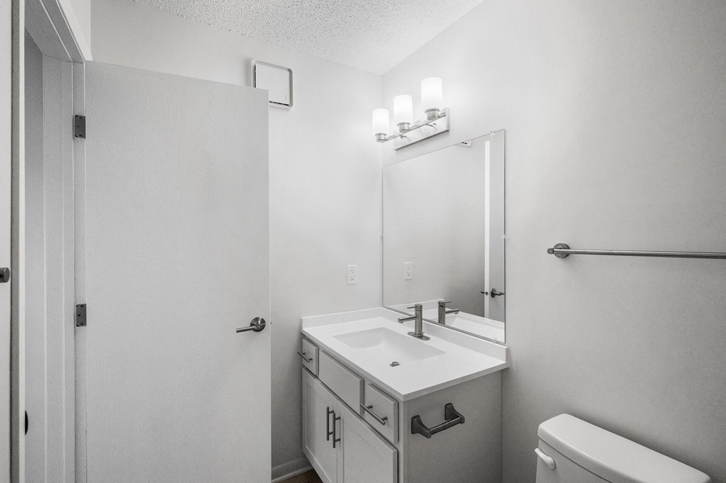 an empty bathroom with a sink and a mirror