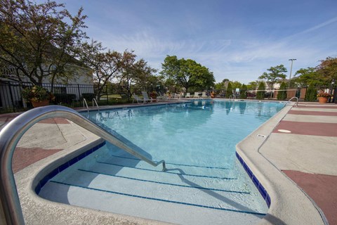 A pool with a metal ladder on the side.