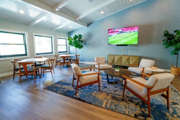 A living room with a television displaying a baseball game.