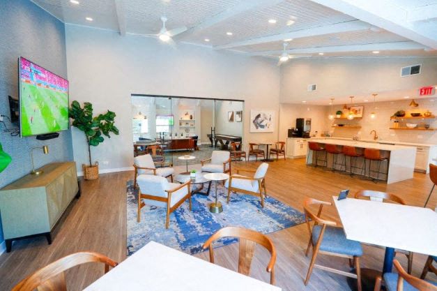 a large living room with tables and chairs
