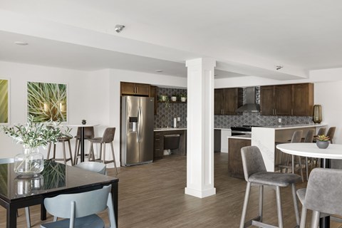 A modern kitchen with a dining table and chairs.