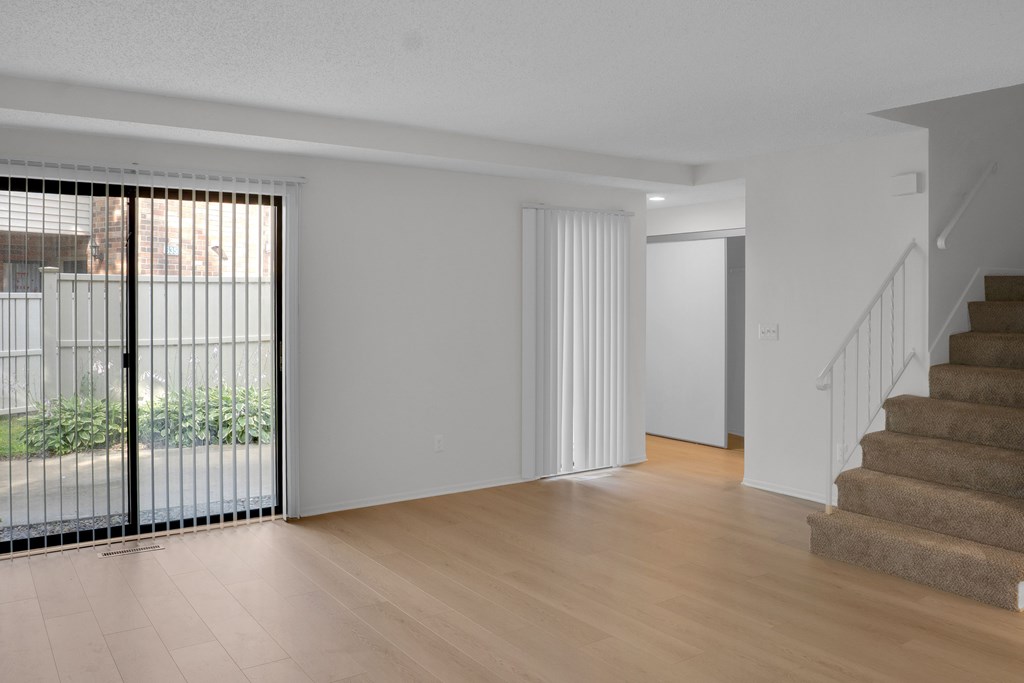 A room with a staircase and a sliding door.