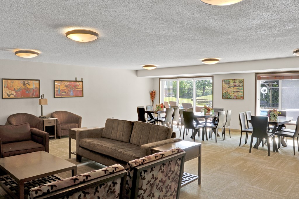 A living room with a couch, chairs, and a coffee table.
