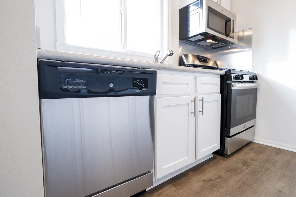 a kitchen with a dishwasher and a stove and a microwave