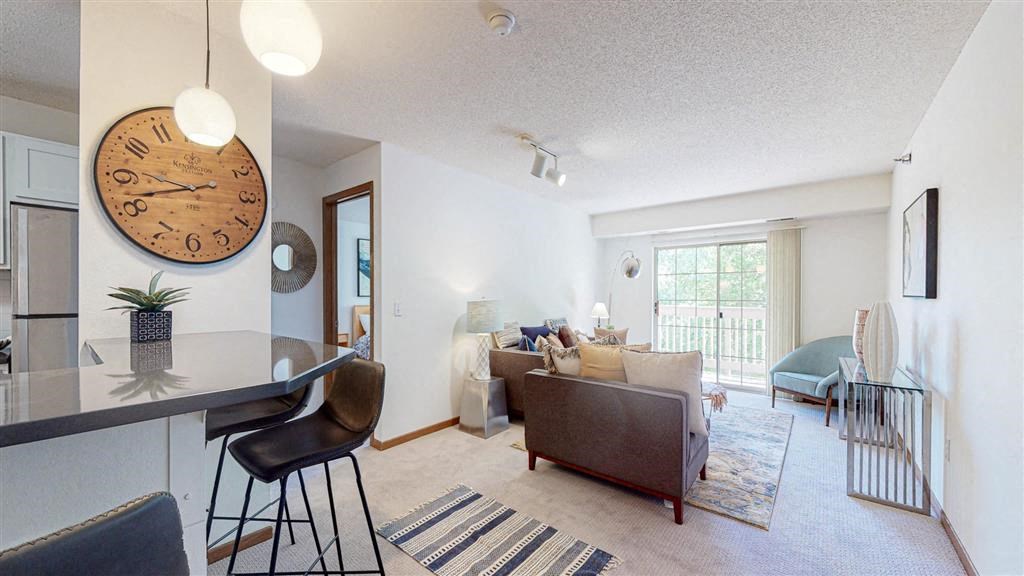 a living room with a large clock on the wall