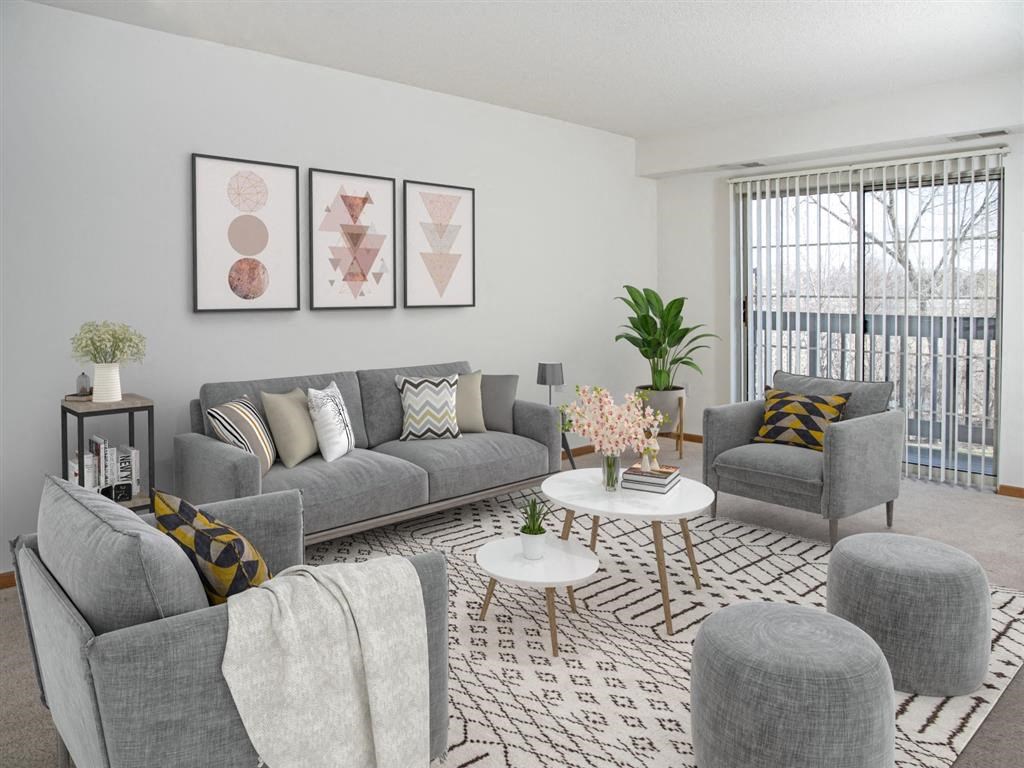 a living room with couches and chairs and a rug