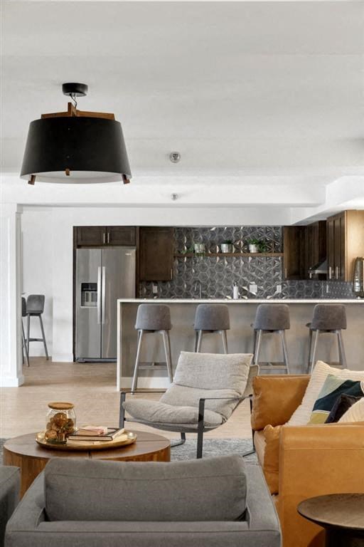 a living room with a table and chairs and a kitchen