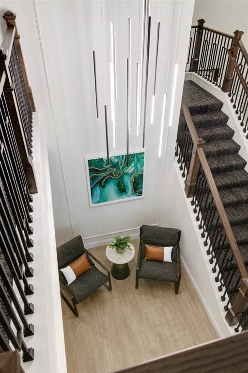 a view of a stairwell with two chairs and a table