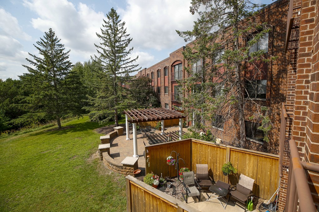 a backyard with a patio and a brick building