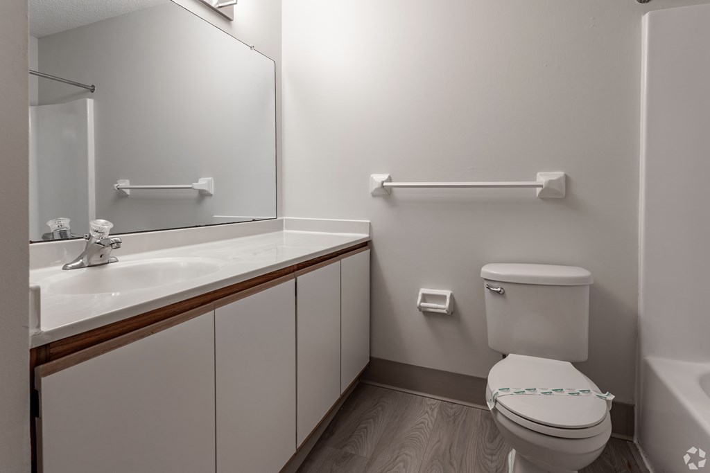 A white toilet with a blue towel in a bathroom.