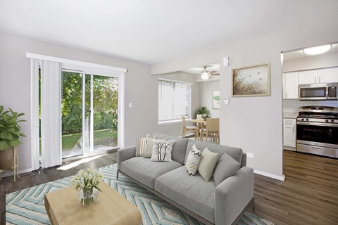 A living room with a grey couch and a wooden coffee table.