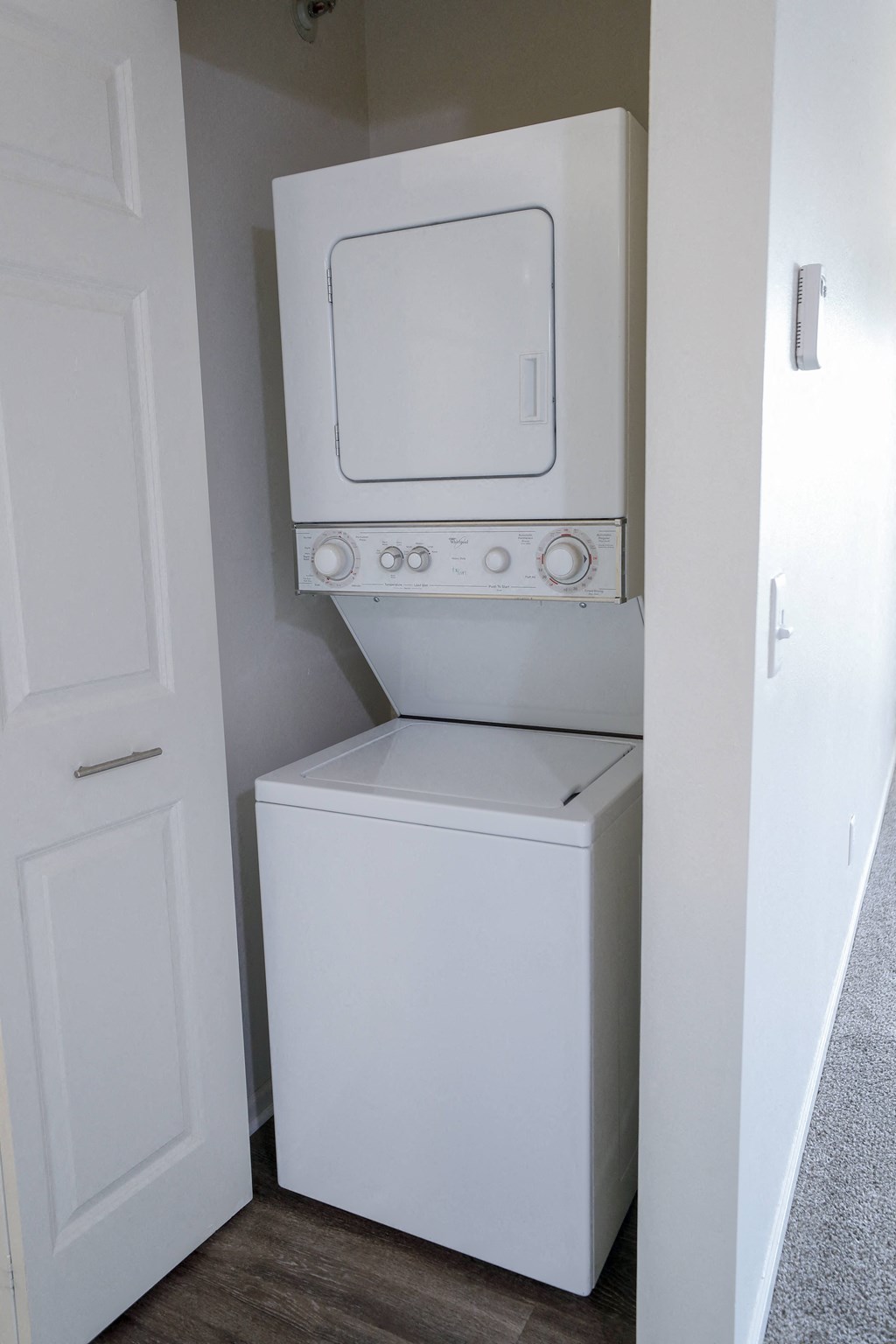 a white washer and dryer in a white closet