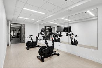 a group of exercise bikes in a room