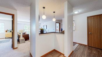 a kitchen with a bar and a living room