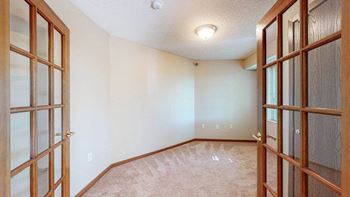 a empty room with a mirrored closet