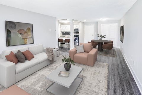 A modern living room with a white couch and a grey coffee table.
