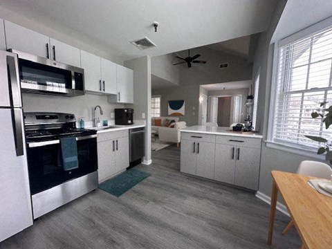 a kitchen with a stove and a microwave and a table
