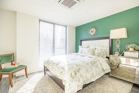 a bedroom with a bed and a dresser and a window