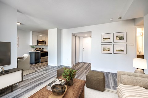 A modern living room with a wooden coffee table and striped sofa.