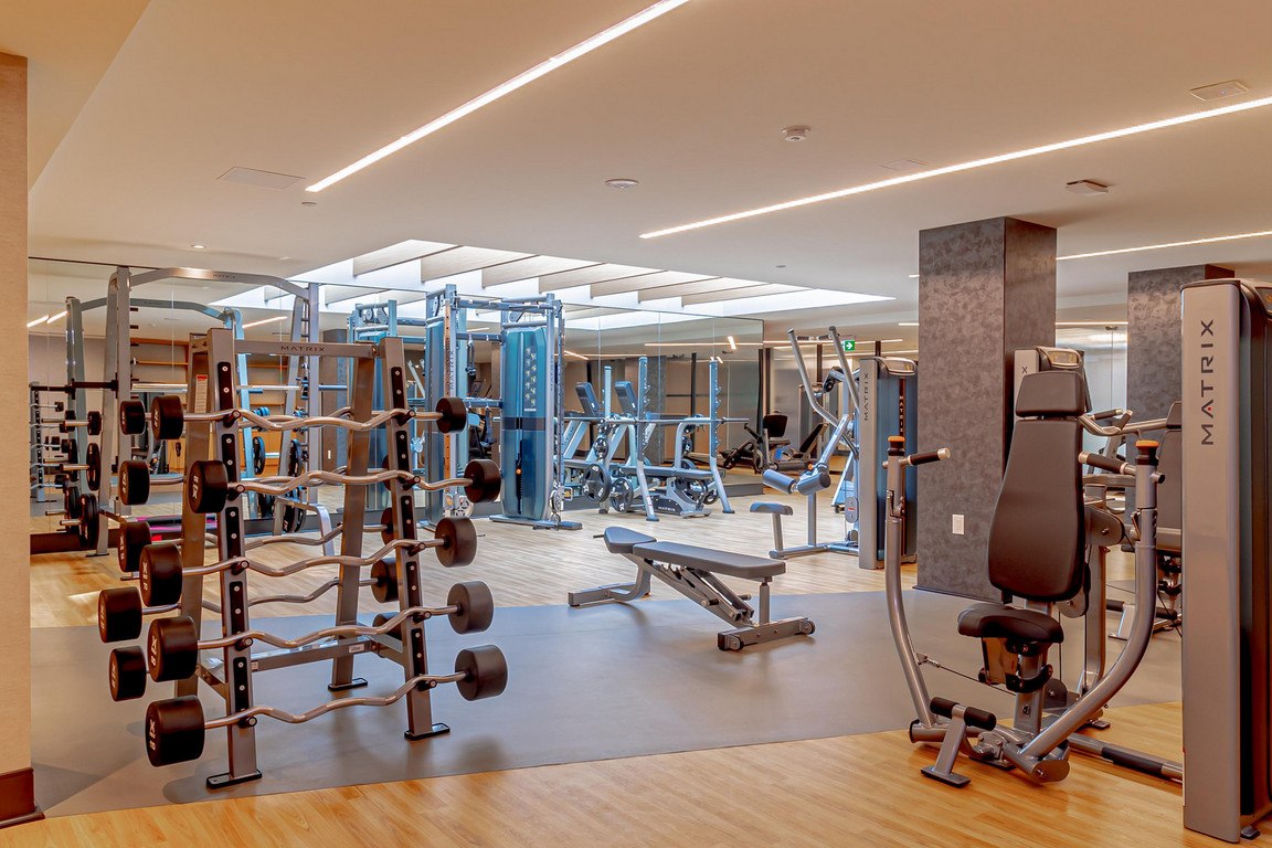 A gym with a variety of equipment including a leg press machine.