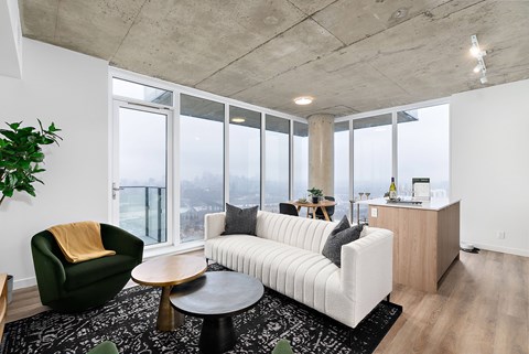 A living room with a white couch, a green armchair, and a wooden coffee table.
