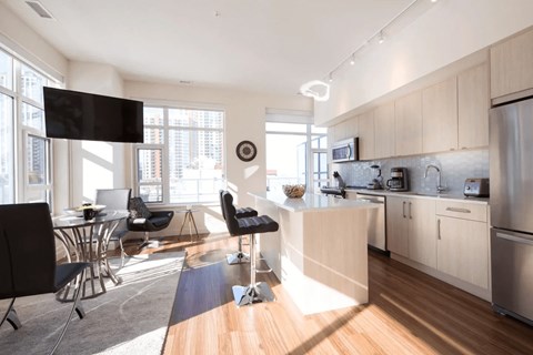 A modern kitchen with a dining table and chairs.