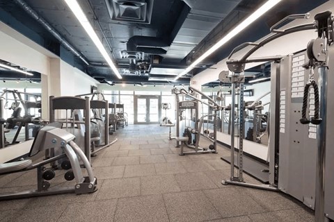 A gym with a variety of equipment including a leg press machine.
