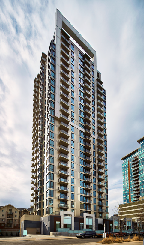 A tall building with many windows is in the foreground.