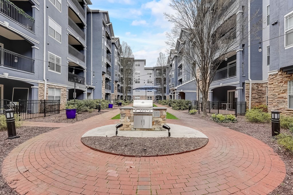A courtyard with a fountain surrounded by apartment buildings.