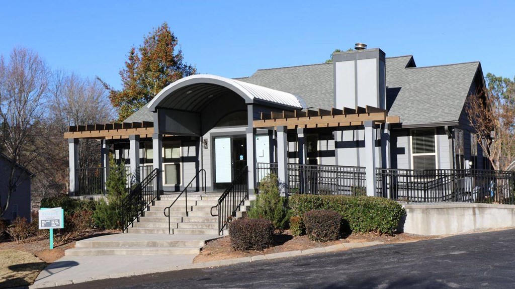 the front of a building with stairs and a porch