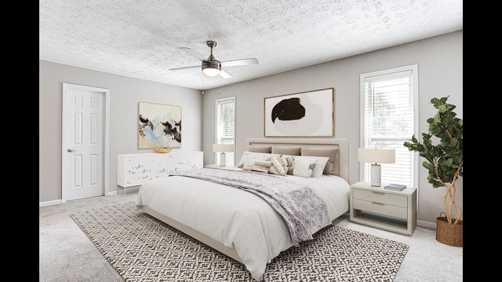 a bedroom with a bed and a ceiling fan