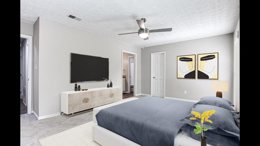 a bedroom with a bed and a tv