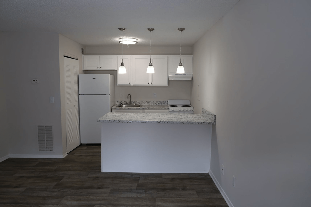 a kitchen with a counter top and a refrigerator