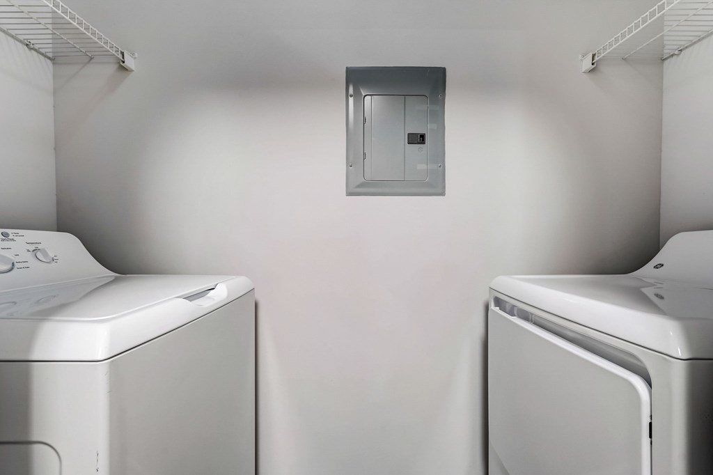 Two washing machines in a laundry room.
