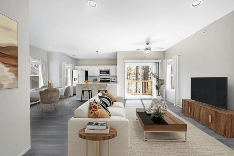 A modern living room with a television and a coffee table.