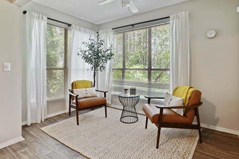 A living room with two chairs and a table.