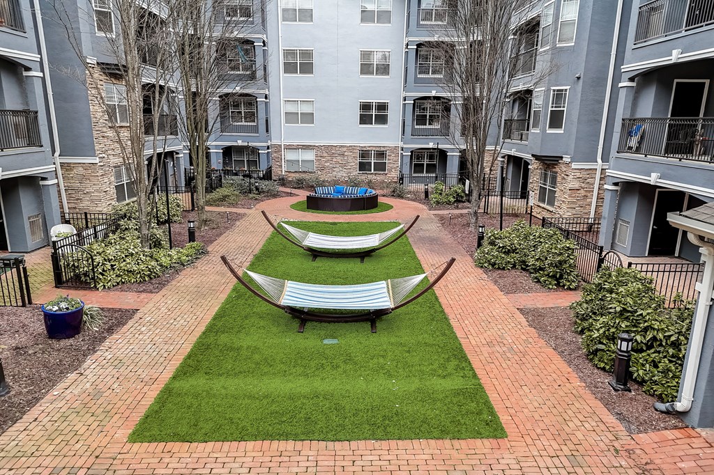 A courtyard with a bench and a small garden.