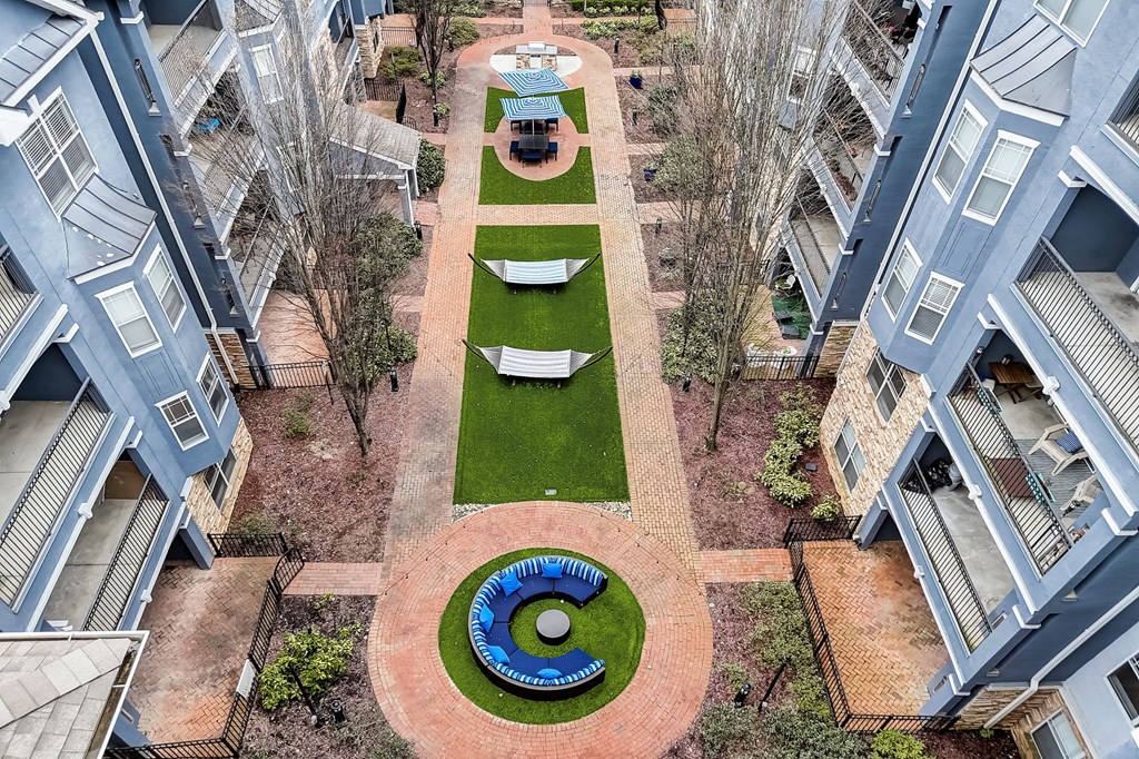 A courtyard with a blue and green design in the middle of it.