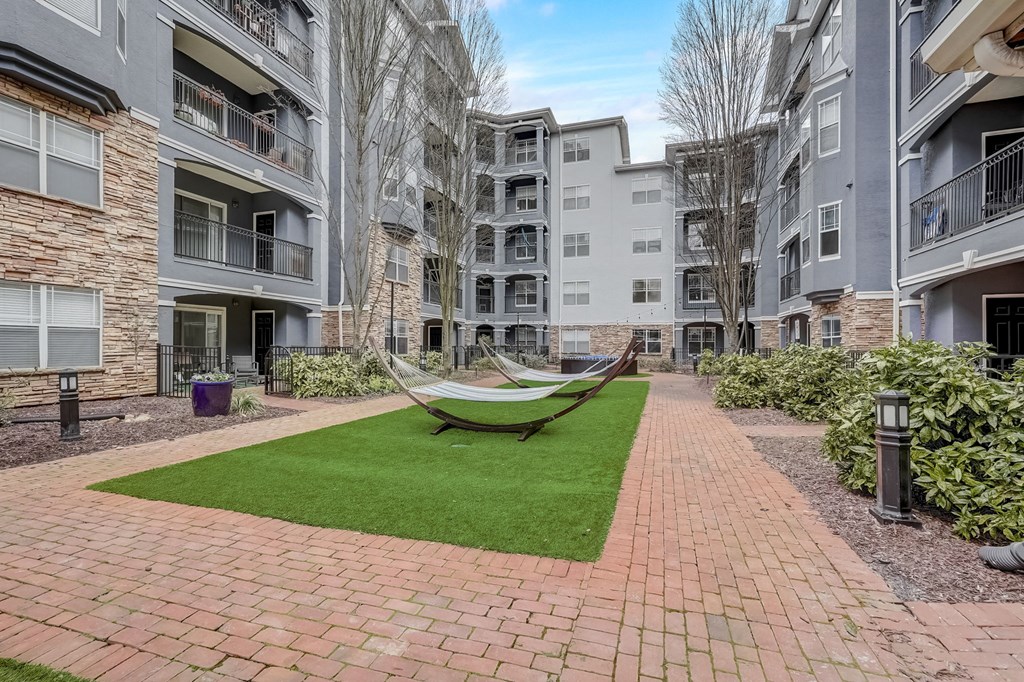 A hammock is strung between two balconies in a courtyard.