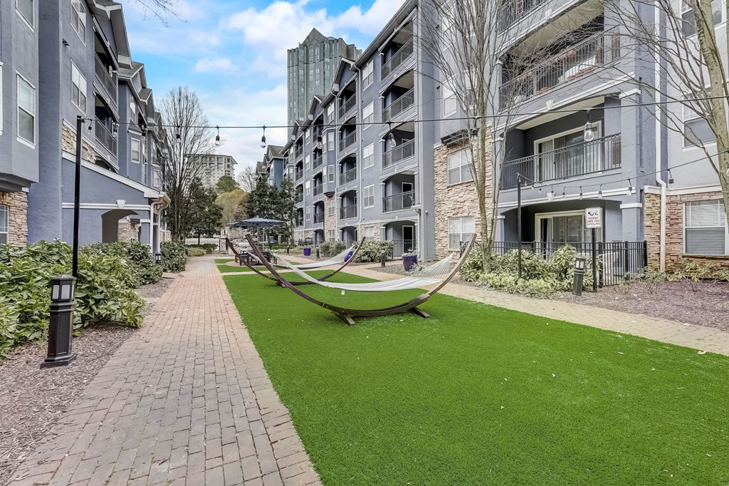A modern residential area with a playground and green grass.
