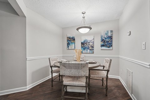 A dining room with a table set for two.
